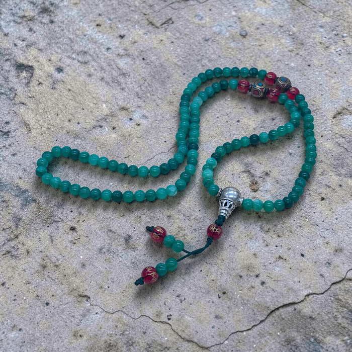 108-bead jade mala with red agate beads inscribed Om Mani Padme Hum