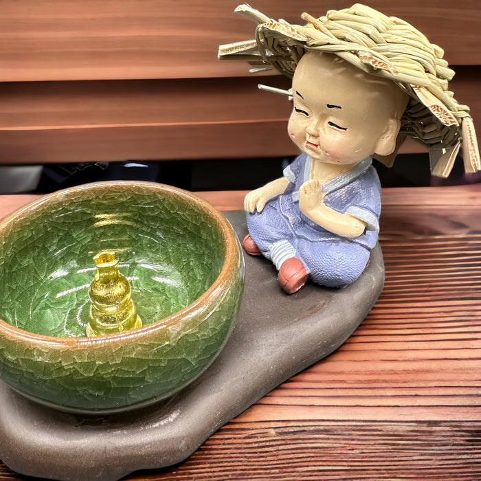 brucia incensi con Buddha bambino