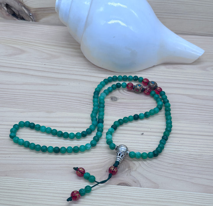 108-bead jade mala with red agate beads inscribed Om Mani Padme Hum