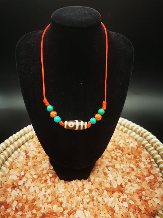 collana tibetana con due occhi dzi e pietri